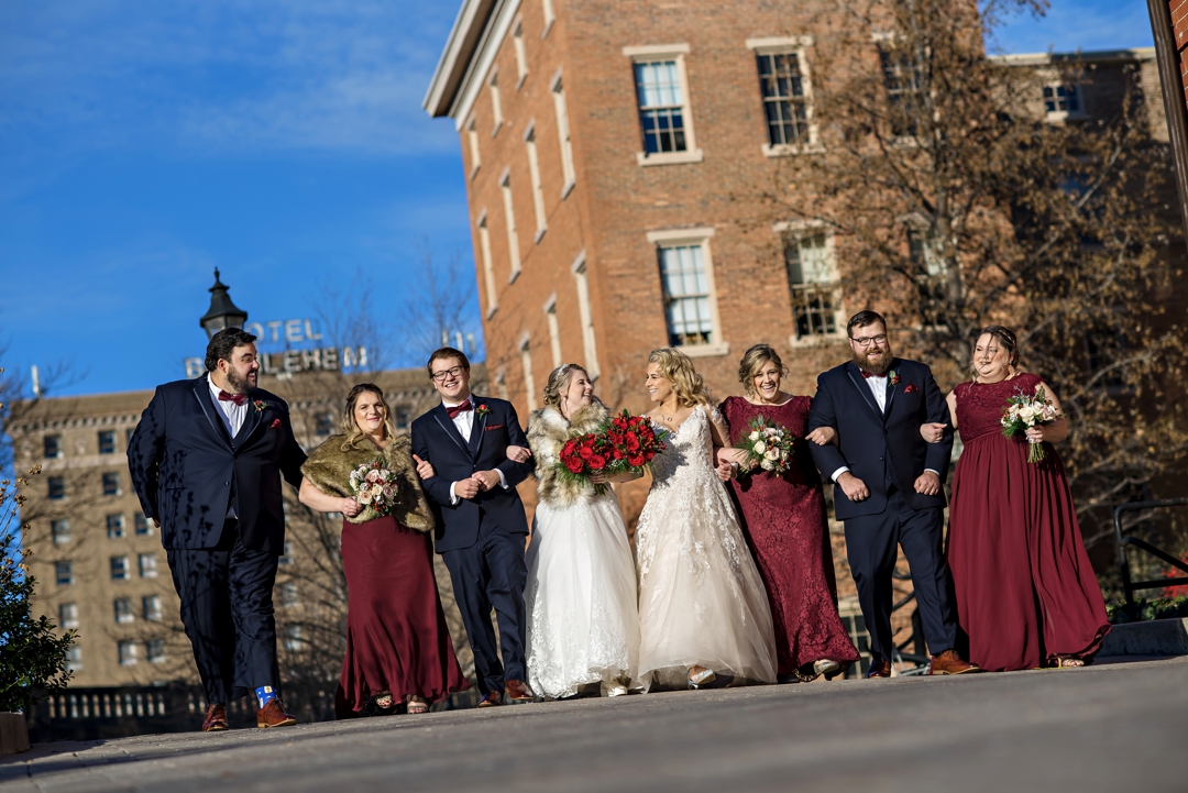 A LGBTQ couple walk with their wedding party outside of the Hotel Bethlehem on their wedding day.