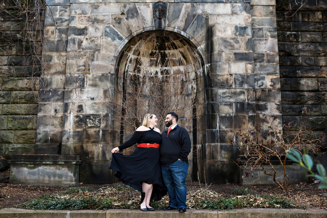An engaged couple hold each other outside of the Philadelphia museum of art.