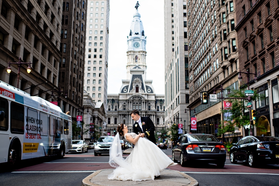 A Navy man dips his new bride on broad street in front of city hall in Philadelphia.