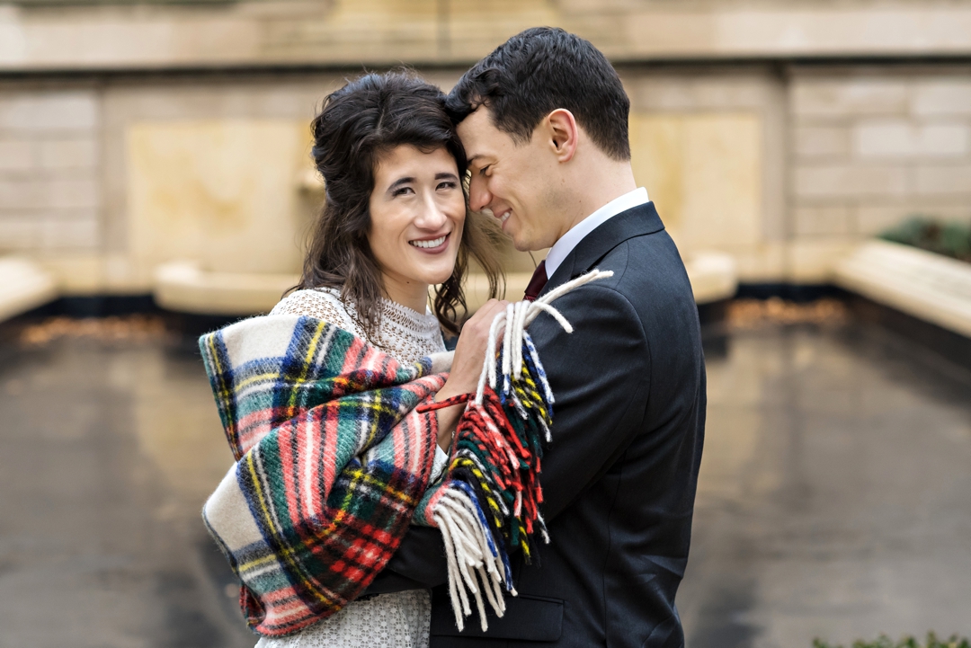 A newly married couple cuddle in the middle of the Rodin Museum on their wedding day.