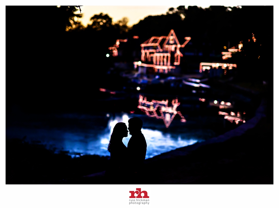 An Engaged Couple kiss in the reflection of Boathouse Row in Philadelphia during their Philadelphia Engagement Session.