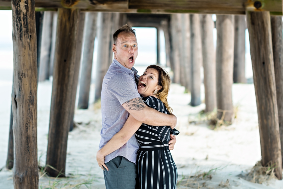 An engaged couple get handsy under a pier in Cape May.