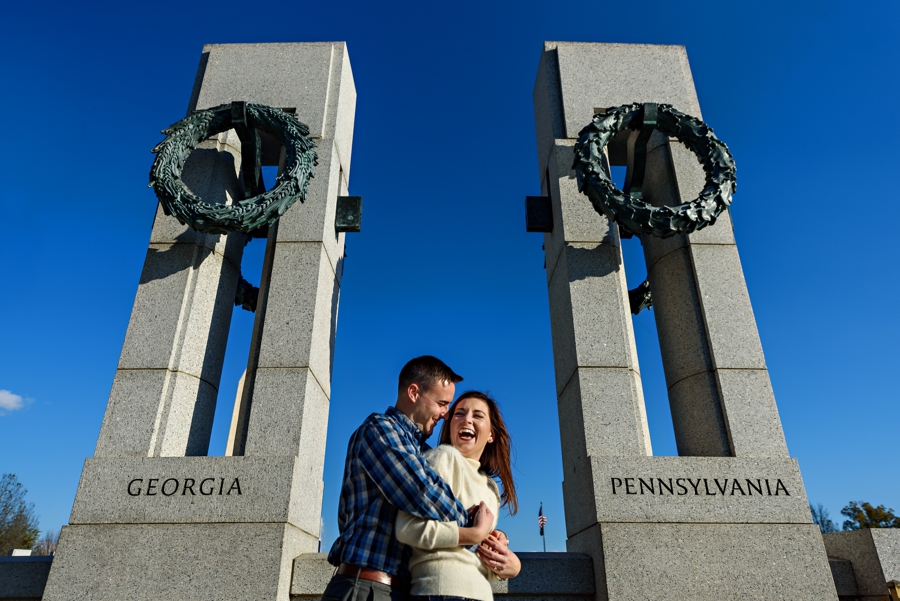 A Navy Couple hug inbetween their home states at the WWII Memorial in thier DC engagement Session.