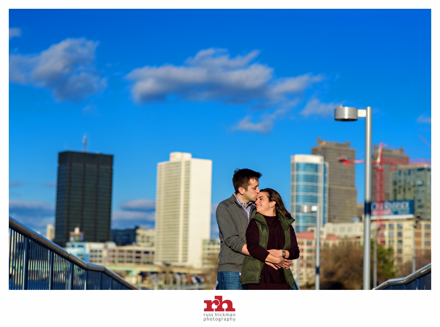 Engaged Couple in front of the Philadelphia Skyline enjoy a kiss.