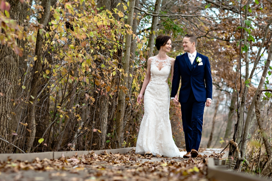 A newly married couple walk along a lake in Bucks County on their wedding day.