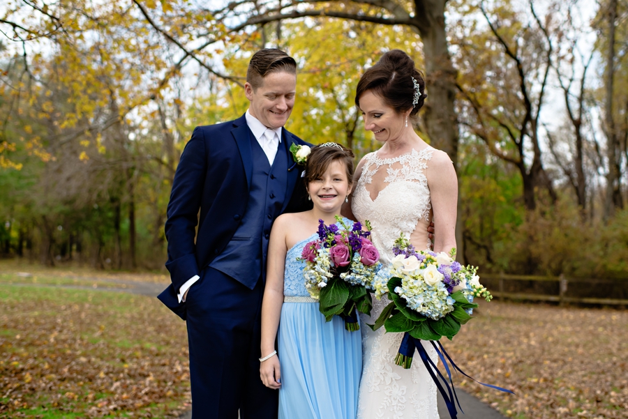 A newly married couple pose with the brides daughter in a park in bucks county PA.